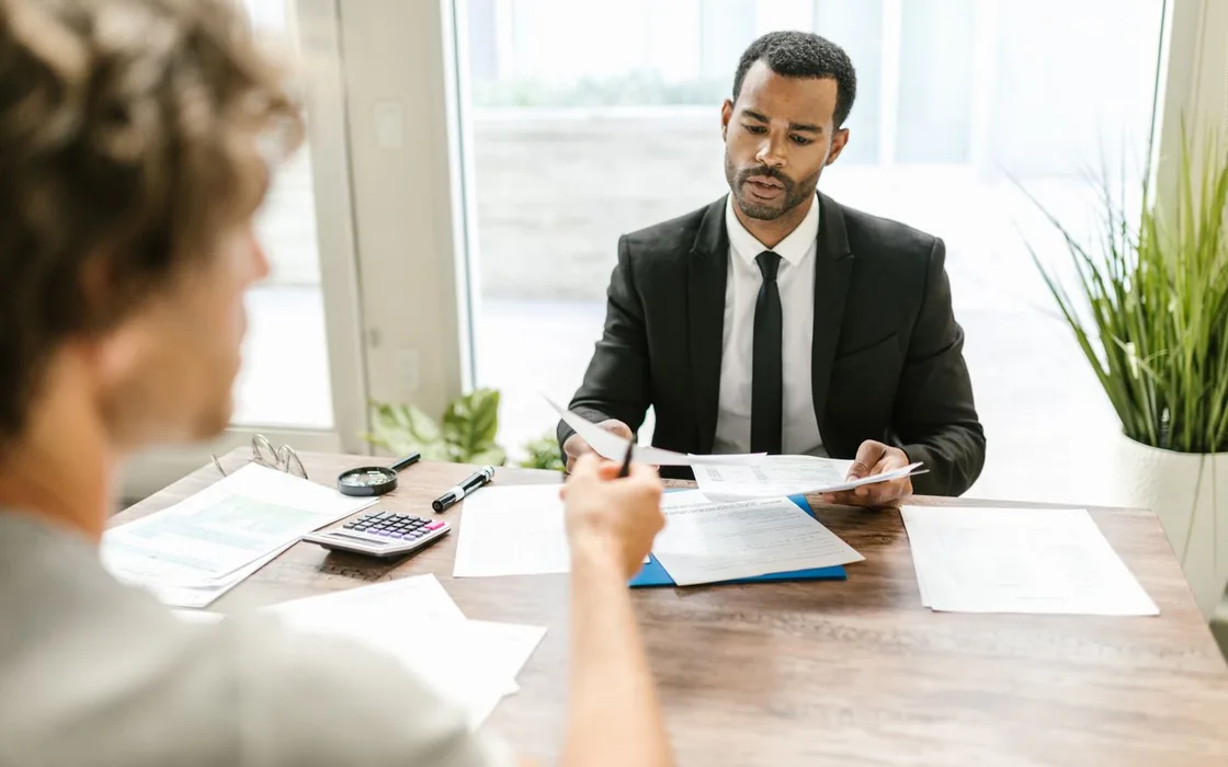 Adviser and business owner setting up an invoicing workflow at a desk
